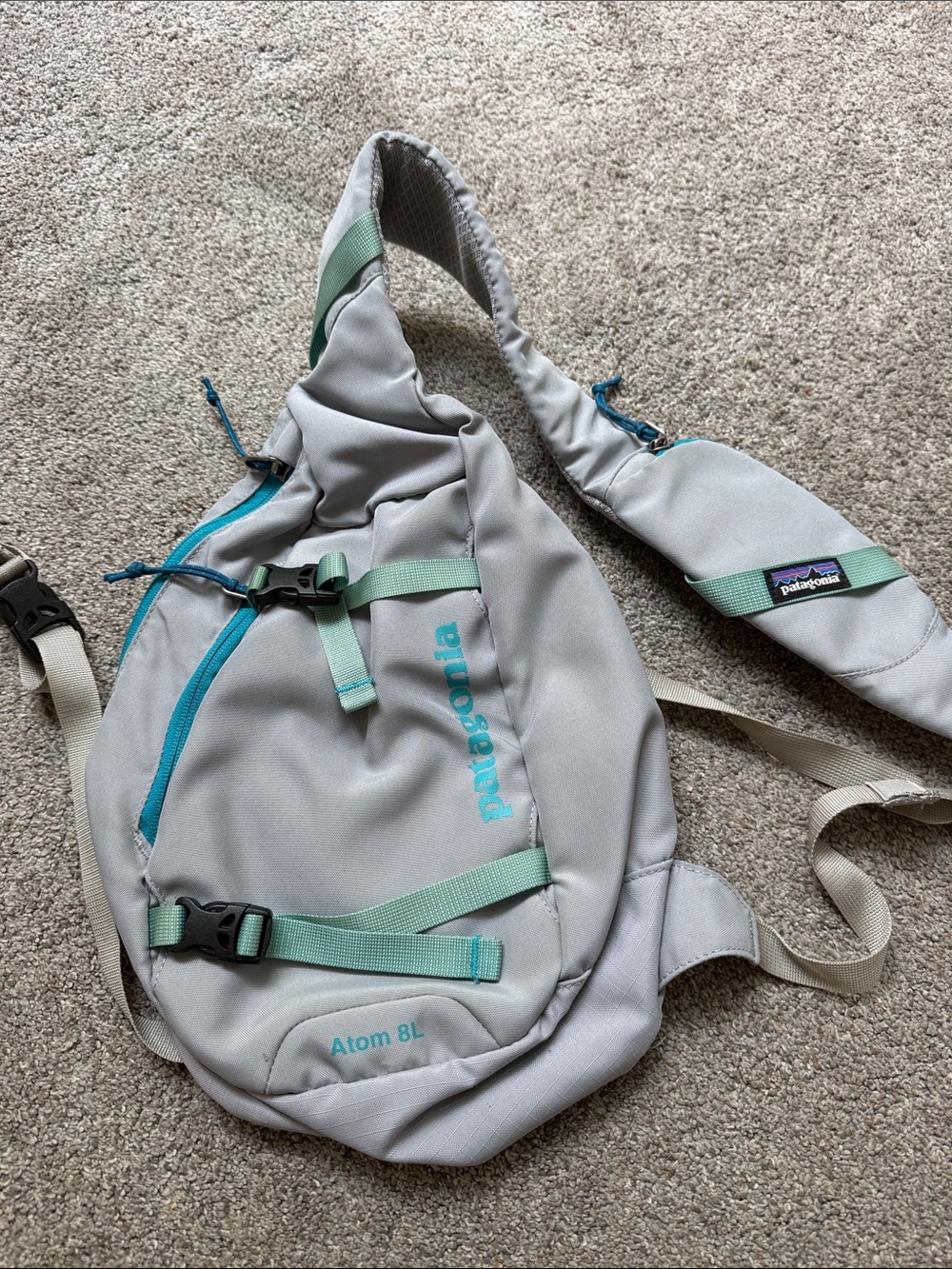 Patagonia Atom 8L Sling Backpack in Light Gray with Teal Accents
